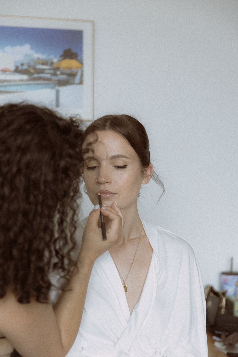 Miah lining a bride's lips on a wedding morning
