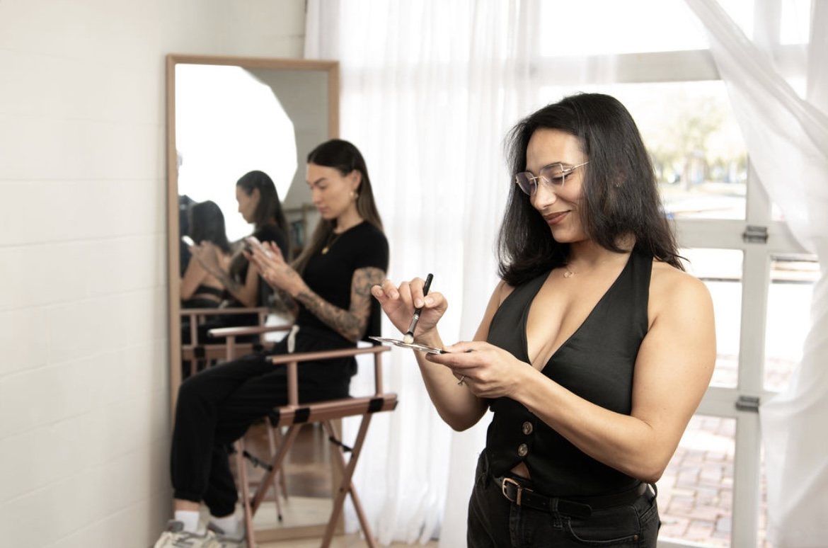 Miah in her studio with a client in the chair